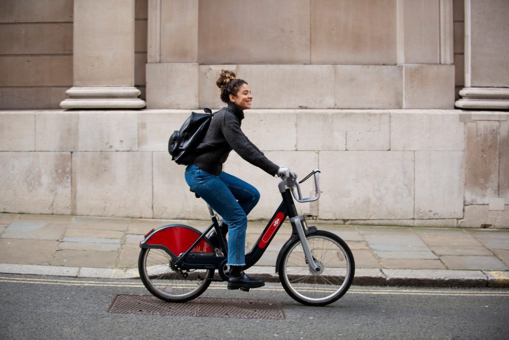 young woman riding bike city